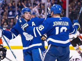 Toronto Maple Leafs left wing Andreas Johnsson (18) celebrates with Mitch Marner after scoring before the NHL pause its schedule March 12.