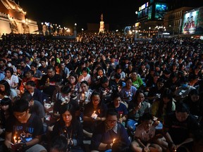 People gather for a candle light vigil following a deadly mass shooting in Nakhon Ratchasima on February 9, 2020.