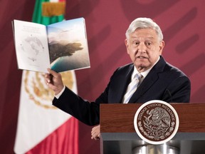 Mexico's President Andres Manuel Lopez Obrador shows a brochure of the 787 Dreamliner plane on Jan. 14, 2020.