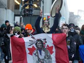 Supporters of Wet'suwet'en hereditary chiefs take part in an anti-pipeline march in Montreal on Feb. 25, 2020.