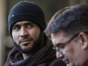 Former Guantanamo Bay prisoner Omar Khadr and his lawyer Nate Whitling speak with media outside the courthouse in Edmonton on February 26, 2019.