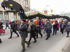 A large protest took over Dundas Street as it left Wellington went up Richmond then down Queens on the way to the RCMP offices on Talbot Street in London, Ont.  A large snake representing a pipeline carries signs that the pipeline is not worth it in terms of health and pollution. They were protesting in solidarity with the Wet'suwet'en Nation who are blockading the Coastal GasLink pipeline in BC  Photograph taken on Tuesday February 11, 2020.