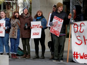 Protestors stand outside the British Columbia Investment Management Corporation as part of a protest against the Coastal GasLink pipeline, in Victoria, British Columbia, Canada February 14, 2020.