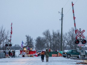 Demonstrators stand near railway tracks during a protest near Belleville, Ont., on Feb. 13, 2020.