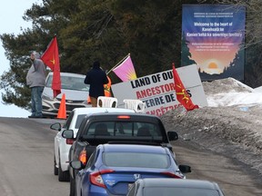 Protesters let vehicles past a check point on a highway in Kanesatake Mohawk Territory, near Oka, Que. on Tuesday, Feb. 25, 2020, as they protest in solidarity with Wet'suwet'en Nation hereditary chiefs attempting to halt construction of a natural gas pipeline on their traditional territories.