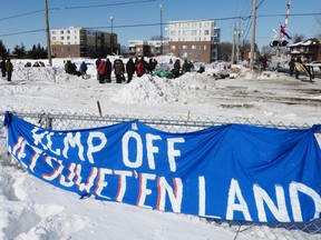 People protest at a rail blockade in St-Lambert, south of Montreal, Que. on Thursday, February 20, 2020 in solidarity with the Wet'suwet'en hereditary chiefs opposed to the LNG pipeline in northern British Columbia.