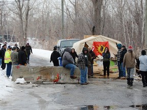 People gather at a protest in Kahnawake, Que. on Tuesday, Feb. 25, 2020, in solidarity with Wet'suwet'en Nation hereditary chiefs attempting to halt construction of a natural gas pipeline on their traditional territories.