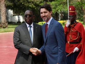 Senegal's president, Macky Sall, left, welcomes Prime Minister Justin Trudeau at the presidential palace in Dakar, Senegal, on Feb. 12.