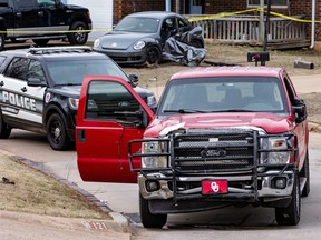 Emergency crews respond to a scene where the red vehicle hit several Moore High School students, killing at least one, in Moore, Okla., Monday, Feb. 3, 2020.