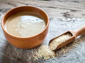 Bowl of tahini with sesame seeds.