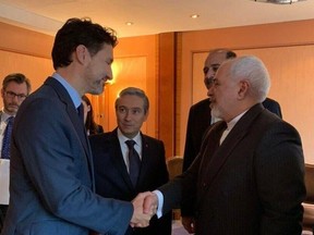 Prime Minister Justin Trudeau shakes handing with Iranian Foreign Minister Javad Zarif at the Munich Security Conference, Friday Feb 14, 2020.