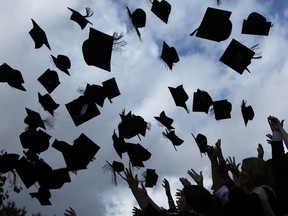 Students throw their mortarboards in the air during their graduation photograph at the University of Birmingham degree congregations  on July 14, 2009 in Birmingham, England.