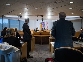 Commissioner Austin Cullen, back centre, listens to introductions before opening statements at the Cullen Commission of Inquiry into Money Laundering in British Columbia, in Vancouver, on Monday, February 24, 2020.