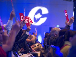 Delegates vote at a Conservative party convention.
