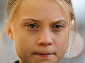 Swedish climate activist Greta Thunberg poses for media as she arrives for a news conference in Davos, Switzerland, Friday, Jan. 24, 2020.