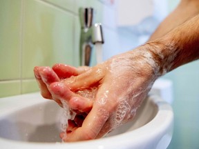 A care centre employee washes his hands following hygiene guidelines on February 27, 2020.