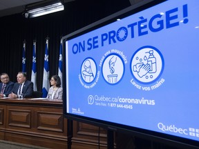 Quebec Premier Francois Legault, flanked by Quebec Minister Responsible for Seniors and Informal Caregivers Marguerite Blais, from the left, Quebec national public health director Horacio Arruda and Quebec Health Minister Danielle McCann, announces measures to contain the COVID-19 virus, Thursday, March 12, 2020 at the legislature in Quebec City.