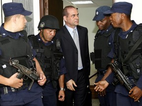 Former paramilitary leader Salvatore Mancuso is escorted by guards to a court in Medellín, Colombia, on Wednesday, May 16, 2007.