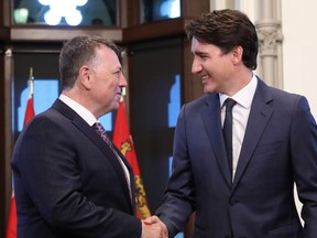 Canada's Prime Minister Justin Trudeau shakes hands with Prince Edward Island Premier Dennis King during a meeting in Trudeau's office on Parliament Hill in Ottawa, Ontario, Canada, July 8, 2019.