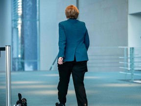 German Chancellor Angela Merkel leaves after making a press statement on the spread of the new coronavirus COVID-19 at the Chancellery, in Berlin on March 22, 2020.