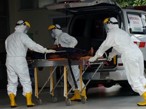 Medical staff wheel a coronavirus suspected patient at Suradadi Hospital after Indonesia confirmed new cases of coronavirus disease (COVID-19), in Tegal, Central Java,  Indonesia, March 11, 2020 in this photo taken by Antara Foto.