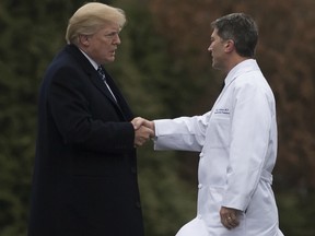 In this file photo taken on Jan. 12, 2018, U.S. President Donald Trump shakes hands with White House Physician Rear Admiral Dr. Ronny Jackson, following his annual physical at Walter Reed National Military Medical Center in Bethesda, Maryland.