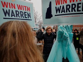 Democratic 2020 U.S. presidential candidate and U.S. Senator Elizabeth Warren (D-MA) reacts to a supporter holding a liberty green dress at a polling site for New Hampshire’s first-in-the-nation primary in Portsmouth, New Hampshire, U.S., February 11, 2020.