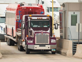 Trucks line up at the Canada Customs booth in Sarnia, Ont., on March 16.