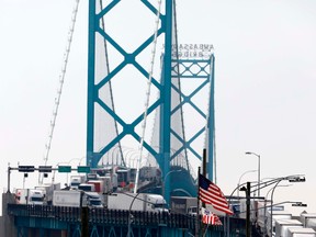 Trucks line up along the Ambassador Bridge, which connects Windsor, Ont., to Detroit, on March 18.