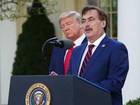 U.S. President Donald Trump, back left, listens as Mike Lindell, CEO of MyPillow Inc., speaks during the daily briefing on the novel coronavirus, at the White House in Washington, D.C., on March 30.