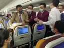 Screen grab of a video posted online of Thai Airways staff restraining a woman by the neck after she coughed 'deliberately' at a flight attendant