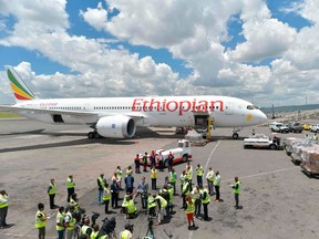 A consignment of masks, testing kits and protective gear, a donation from the Chinese billionaire and Alibaba co-founder Jack Ma, are unloaded from a cargo plane operated by Ethiopian airlines on March 24, 2020 after it arrived at the Jomo Kenyatta airport in Nairobi to help enhance capacity at the COVID-19 coronavirus infection testing centres in Kenya.