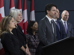 Prime Minister Justin Trudeau listens to a question with Deputy Prime Minister and Minister of Intergovernmental Affairs Chrystia Freeland, Minister of Health Patty Hajdu, Chief Medical Officer Theresa Tam, Minister of Finance Bill Morneau and President of the Treasury Board Jean-Yves Duclos during a news conference on the coronavirus situation, in Ottawa, Wednesday March 11, 2020.