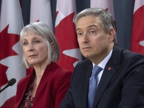 Minister of Foreign Affairs Francois-Philippe Champagne and Minister of Health Patty Hajdu listen to a question from the media during a news conference in Ottawa, Monday March 9, 2020.