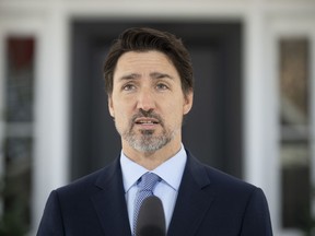 Prime Minister Justin Trudeau speak to the media during a news conference about the COVID-19 virus outside Rideau Cottage in Ottawa, Wednesday March 18, 2020.