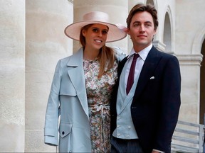 In this file photo taken on October 19, 2019, Britain's Princess Beatrice and property tycoon Edoardo Mapelli Mozzi arrive to attend the wedding of prince Napoleon and Countess Olympia Arco-Zinneberg at the Saint-Louis-des-Invalides cathedral at the Invalides memorial complex in Paris.