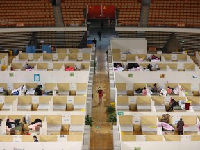 This photo taken on March 5, 2020 shows  patients resting at a temporary hospital set up for COVID-19 coronavirus patients in a sports stadium in Wuhan, in China's central Hubei province.