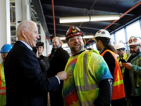 U.S. presidential candidate and former vice-president Joe Biden greets workers during a campaign stop at the FCA (Fiat Chrysler Automobiles) Mack Assembly plant in Detroit, Mich., on March 10, 2020.