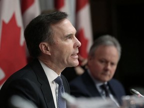 Finance Minister Bill Morneau with Bank of Canada Governor Stephen Poloz during a news conference on Parliament Hill March 18, 2020 in Ottawa.