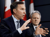 Finance Minister Bill Morneau and Bank of Canada Governor Stephen Poloz at a news conference in Ottawa on March 13, 2020.