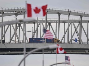 A truck crosses the Bluewater Bridge border crossing between Sarnia, Ontario and Port Huron, Michigan, March 16, 2020.