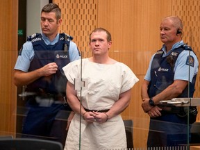 In this file photo taken on March 16, 2019, Brenton Tarrant (C), the man charged in relation to the Christchurch massacre, stands in the dock during his appearance at the Christchurch District Court.