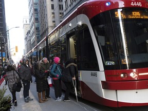 Passengers board a Toronto Transit Commission (TTC) streetcar in the financial district of Toronto, Ontario, Canada, on Friday, Feb. 21, 2020.