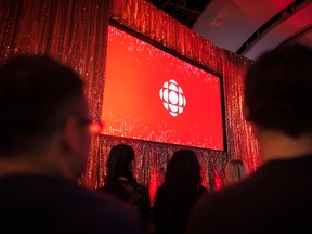The CBC logo is projected onto a screen during a presentation in Toronto on May 29, 2019. CBC journalists are objecting to paid content at the public broadcaster.