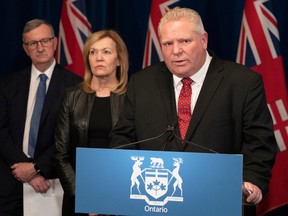 Ontario Premier Doug Ford, centre right, answers questions during a news conference at the Ontario legislature in Toronto on March 16.
