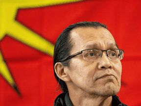 Frank Alec, whose hereditary name is Chief Woos, listens as members of the Tyendinaga Mohawk Territory and Wet'suwet'en Nation speak at a news conference in Tyendinaga, Ont., on Feb. 21, 2020.