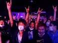 Fans wearing protective masks react while enjoying a band's performance at Hidden Agenda: This Town Needs (TNN) Live House during the club's last concert as business plummets due to the fear of the coronavirus, in Hong Kong, China February 27, 2020.