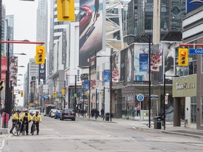 Toronto Police Services officers on bicycles patrol Yonge Street in Toronto during ongoing concerns of the Covid 19 virus, Thursday March 19, 2020. [Peter J Thompson] [For National story by TBA/National]