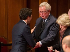 Prime Minister Justin Trudeau speaks with former Prime Minister Joe Clark following the Speech from the Throne in Ottawa, Canada on December 4, 2015.