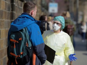 People line up for to be tested for the COVID-19 coronavirus in Dresden, Germany.